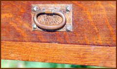 Detail oval pull with pyramid screws, worn original patina.